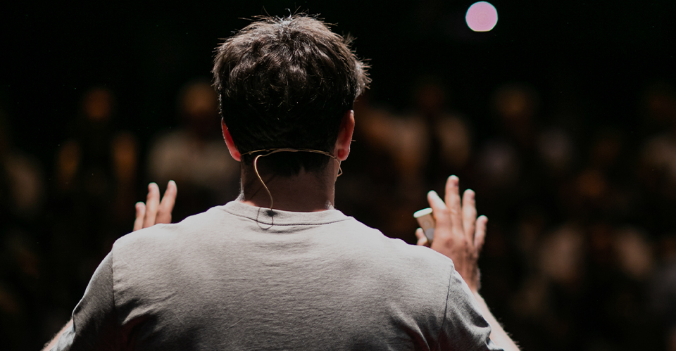 Speaker addressing an audience from behind.