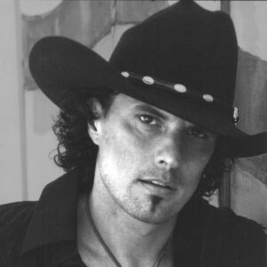 Black and white portrait of a man wearing a cowboy hat.